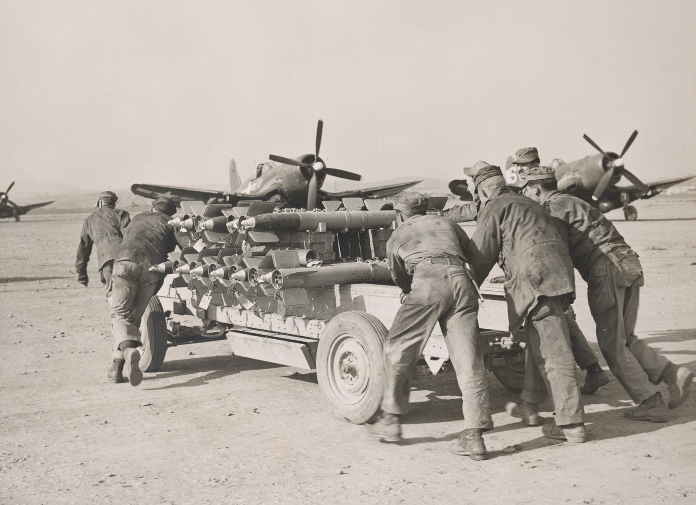 us marine f4u fighters being armed on airfield