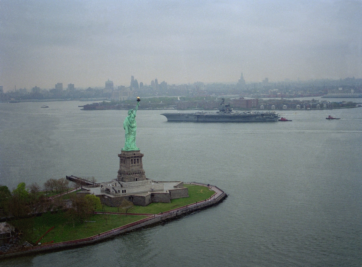 uss forrestal sails past the statue of liberty