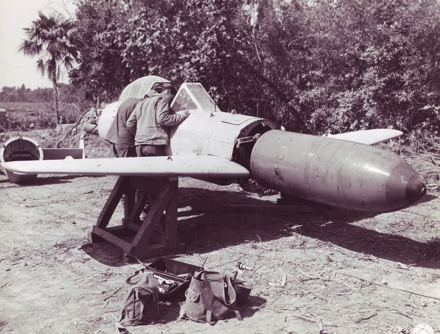 us marines inspecting a baka on okinawa