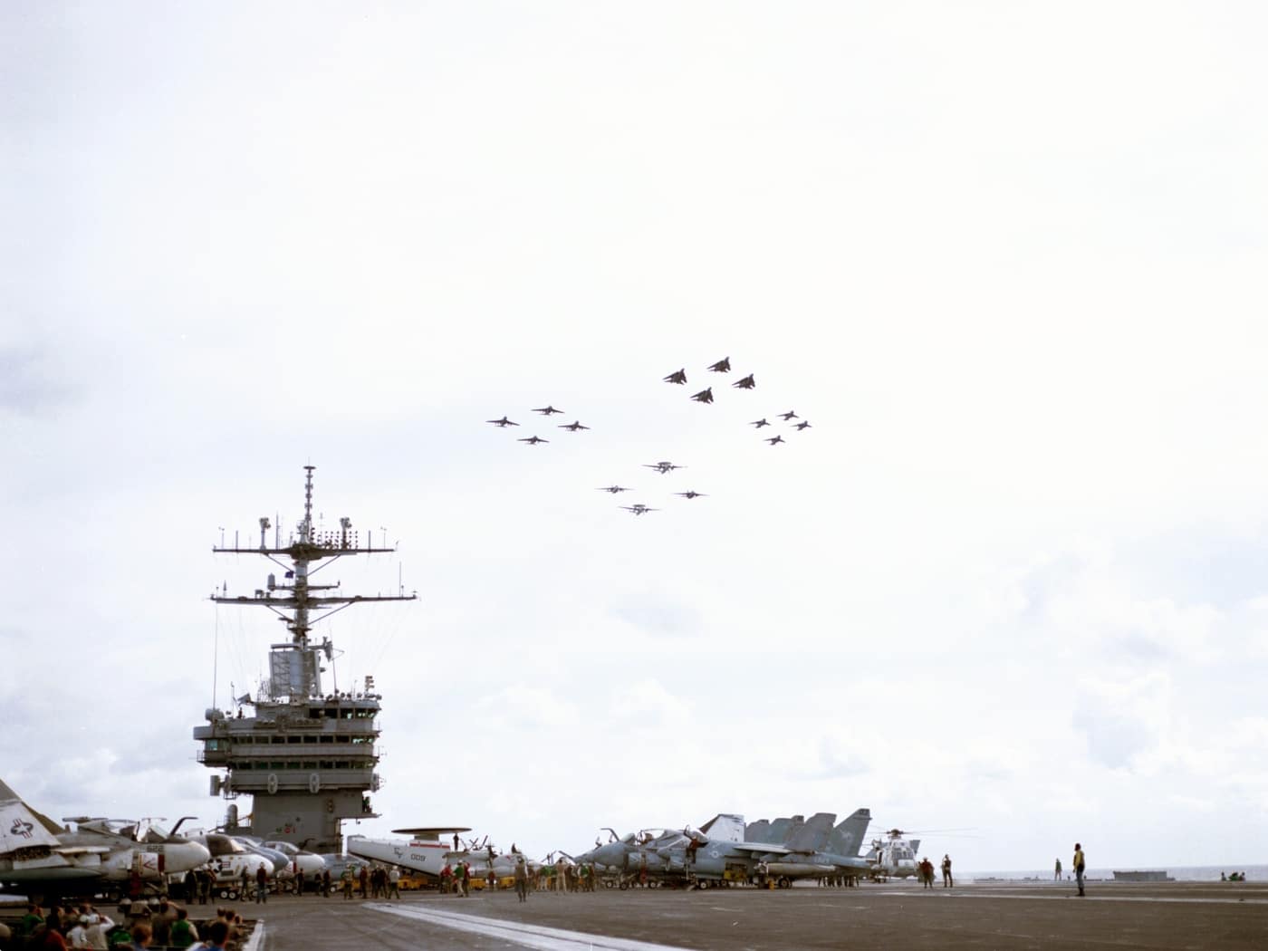 us navy aircraft flying over the uss nimitz