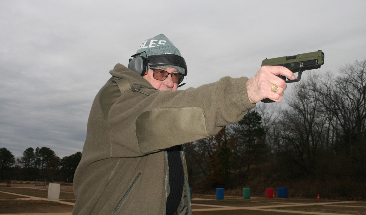 author teaching how to shoot a gun