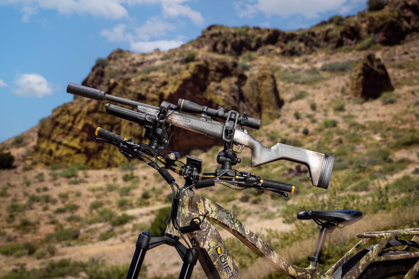 carrying a hunting rifle on an electric bike in the desert and woods