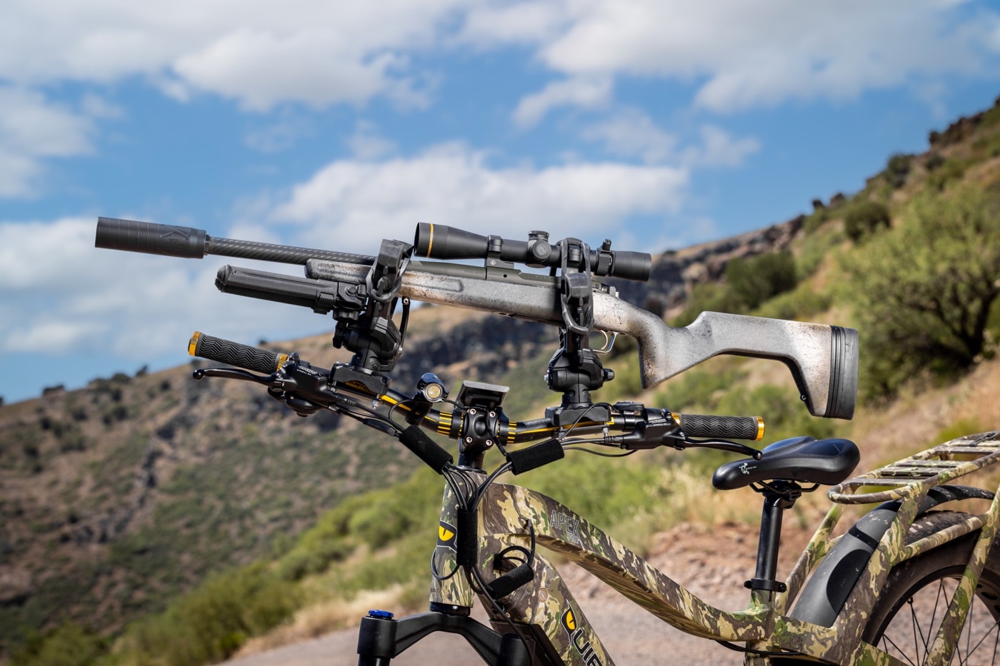 hunting rifle with scope suppressor stock mounted on apex pro e-bike