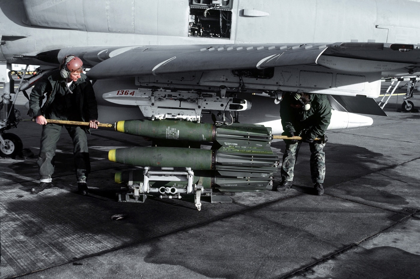 sailors load mark 81 he bombs on a-4 skyhawk nas fallon nevada