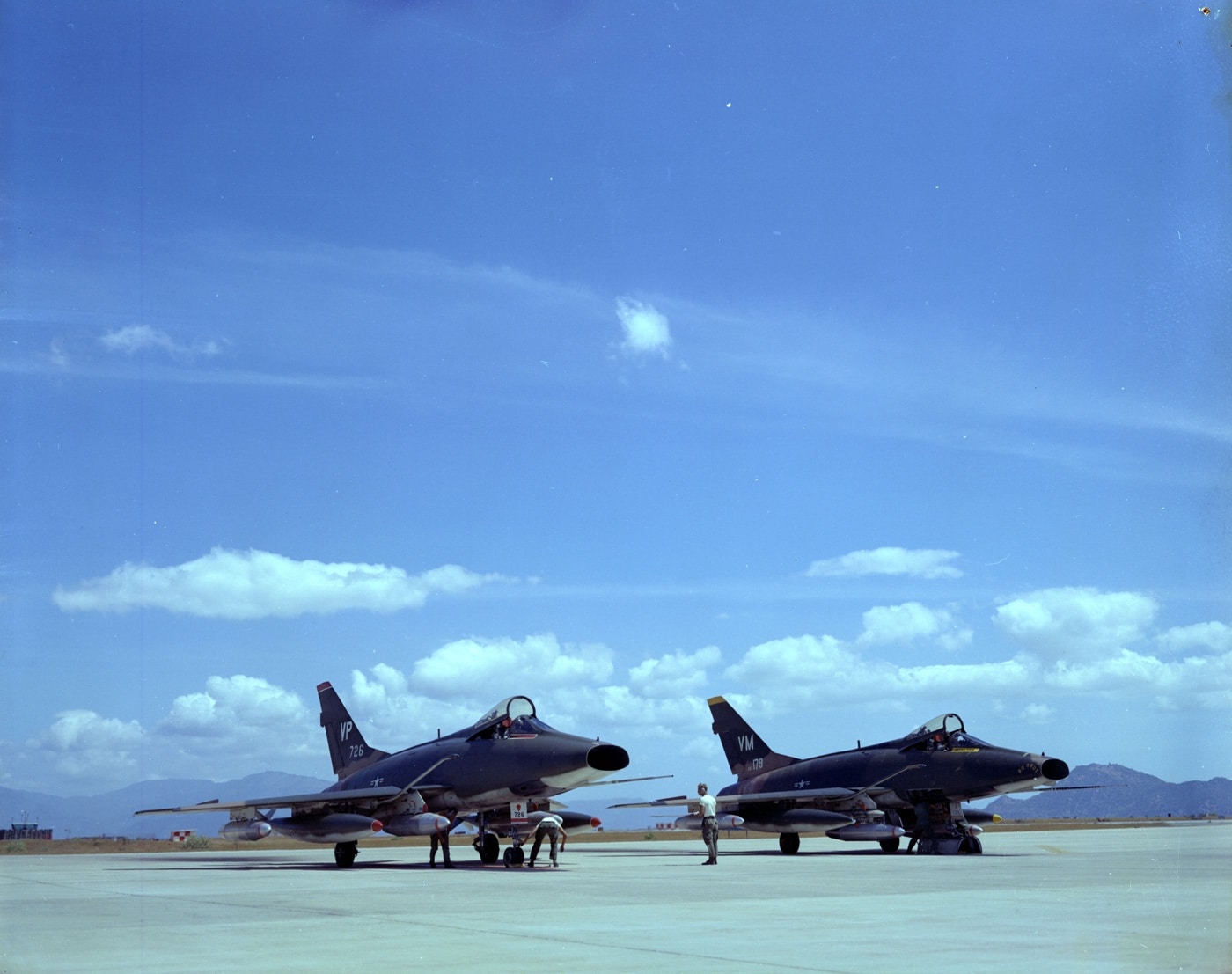 two f-100 super sabre fighter bombers armed for a mission at phan rang ab in south vietnam