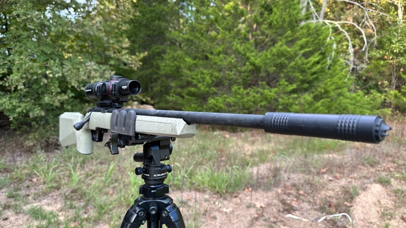 author owned springfield waypoint model 2020 rimfire rifle in tripod mount rimfire sound suppressor in field for testing