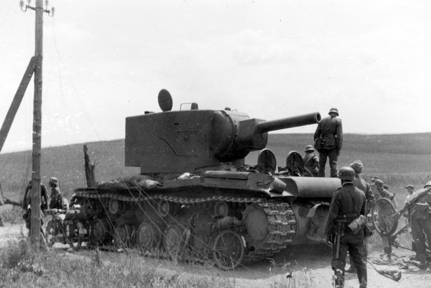 german soldiers examine damaged russian kv-2 heavy tank in world war 2 soviet union ussr