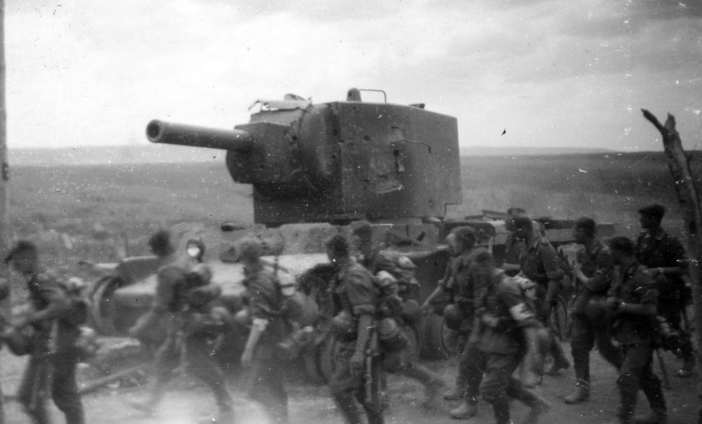 german soldiers troops march by soviet army kv-2 heavy tank armored vehicle