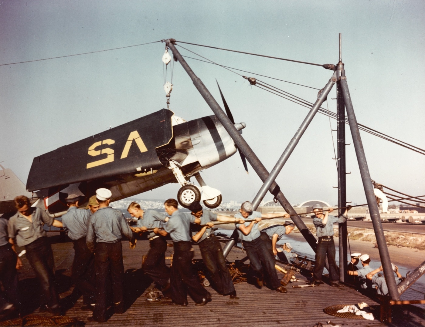 loading a hellcat fighter onto a ship in san diego california