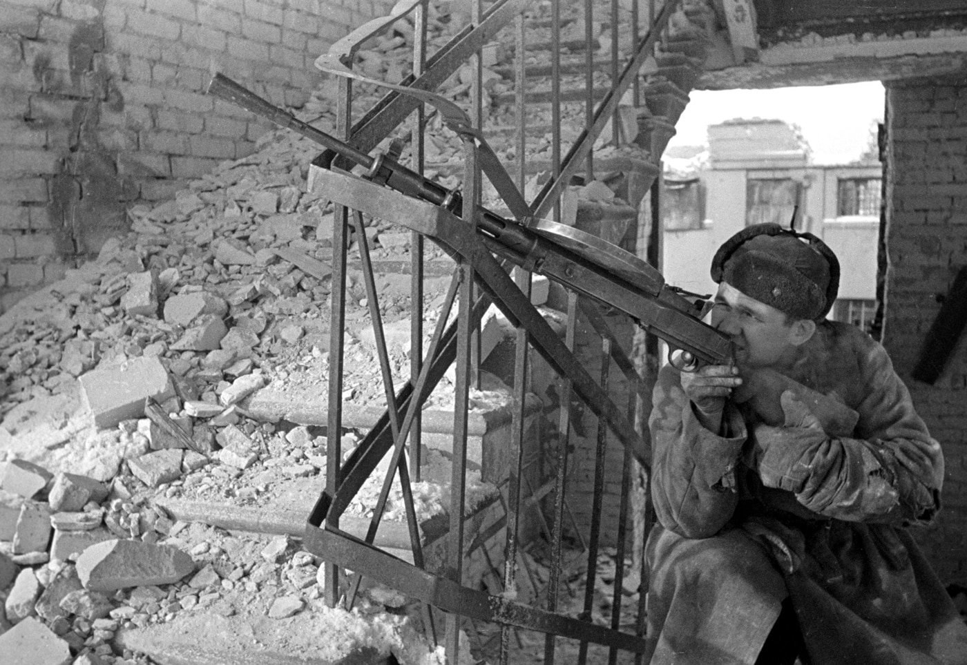 soviet machine gunner with dp-27 in bombed house in stalingrad russia