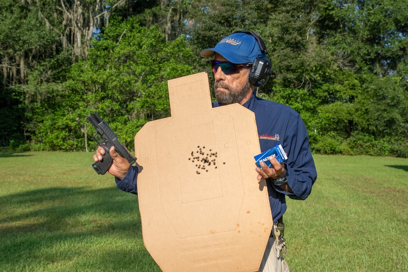 The author poses with his qualification target that he shot with the new Springfield Armory Echelon pistol. Equipped with night sights, the gun was accurate and fast to shoot. He found it was a joy to shoot.