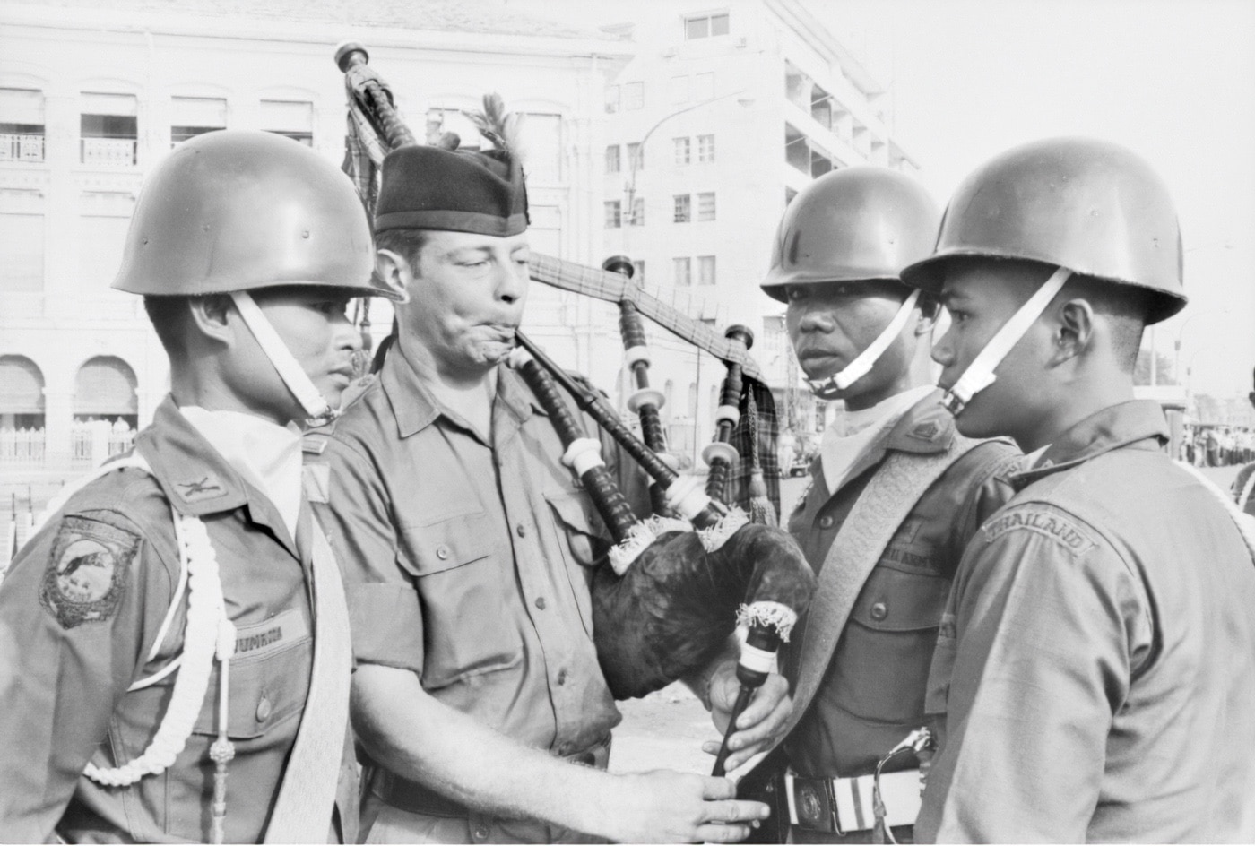 In this unusual photo, Pipe Major (Sergeant) Jack Elliott of the Royal Australian Regiment (3RAR) Pipe Band plays the bagpipes for Thai soldiers in Saigon during the Armed Forces Day parade, June 1971. The parade included members of all allied forces in the Vietnam War and is an interesting part of Cold War history.