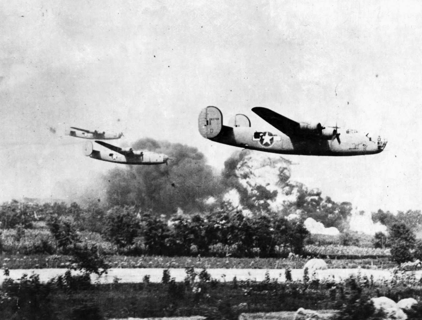 In this photo, three B-24 bombers fly low over a field as they make a bombing run on the oil refinery in Rumania. A fighter group based near there was the source of repatriation for the Americans through Operation Reunion. While Germans were bombing elsewhere, Popesti airfield personnel and Romanian fighters were able to avoid the Soviet occupation. 