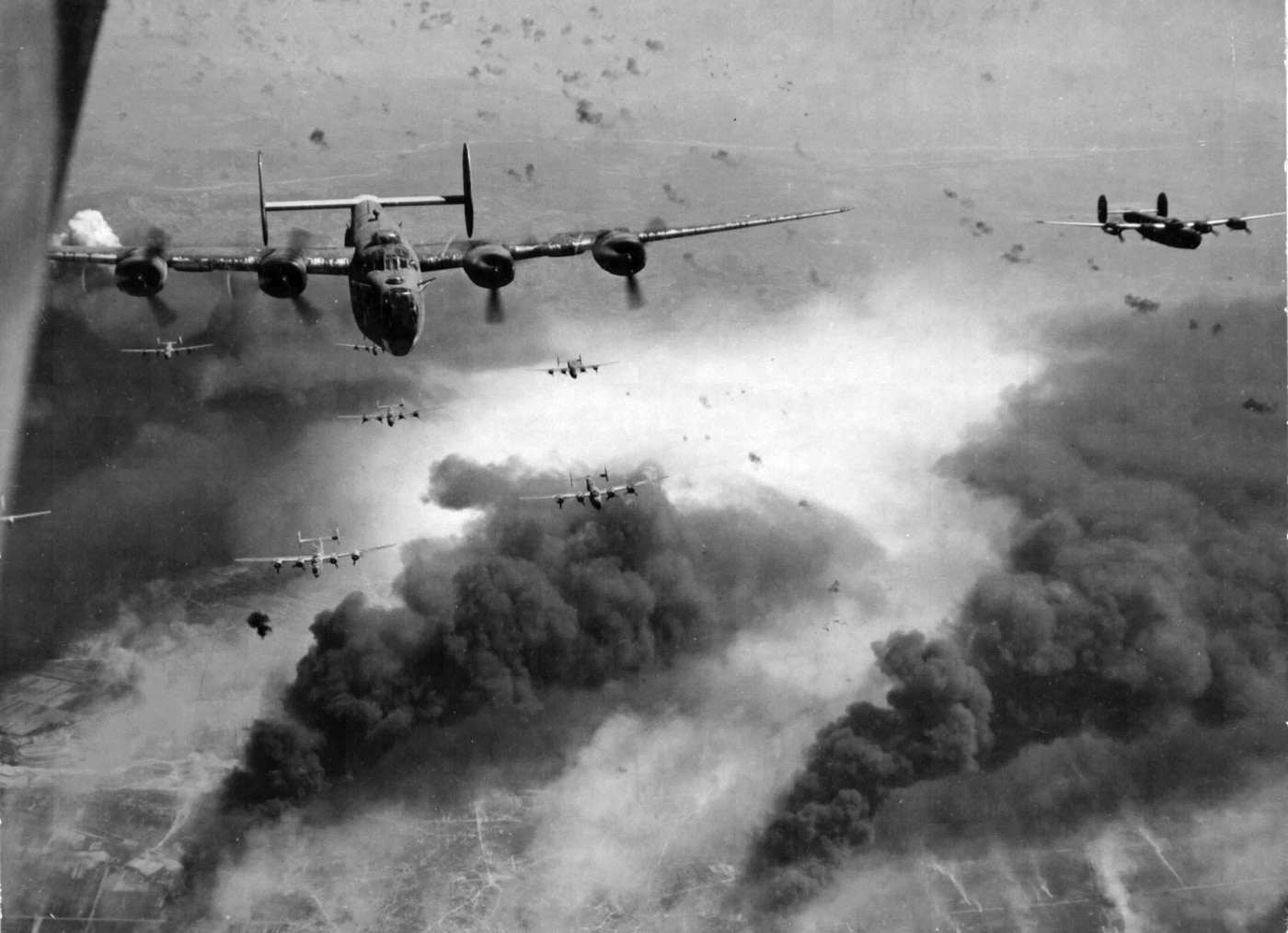Shown in this photo are US Army Air Force strategic bombers attacking Ploesti, Romania. This was the beginning of what we now know as Operation Gunn. One of the bombers was piloted by Lt. Col. Gunn. It was shot down and he survived. Gunn was housed with allied prisoners of war held by Romania. Fortunately, Gunn was able to hitch a ride with Romanian Captain Constantin Cantacuzino who was able to transport him to the Fifteenth Air Force headquarters base at San Giovanni airfield. 