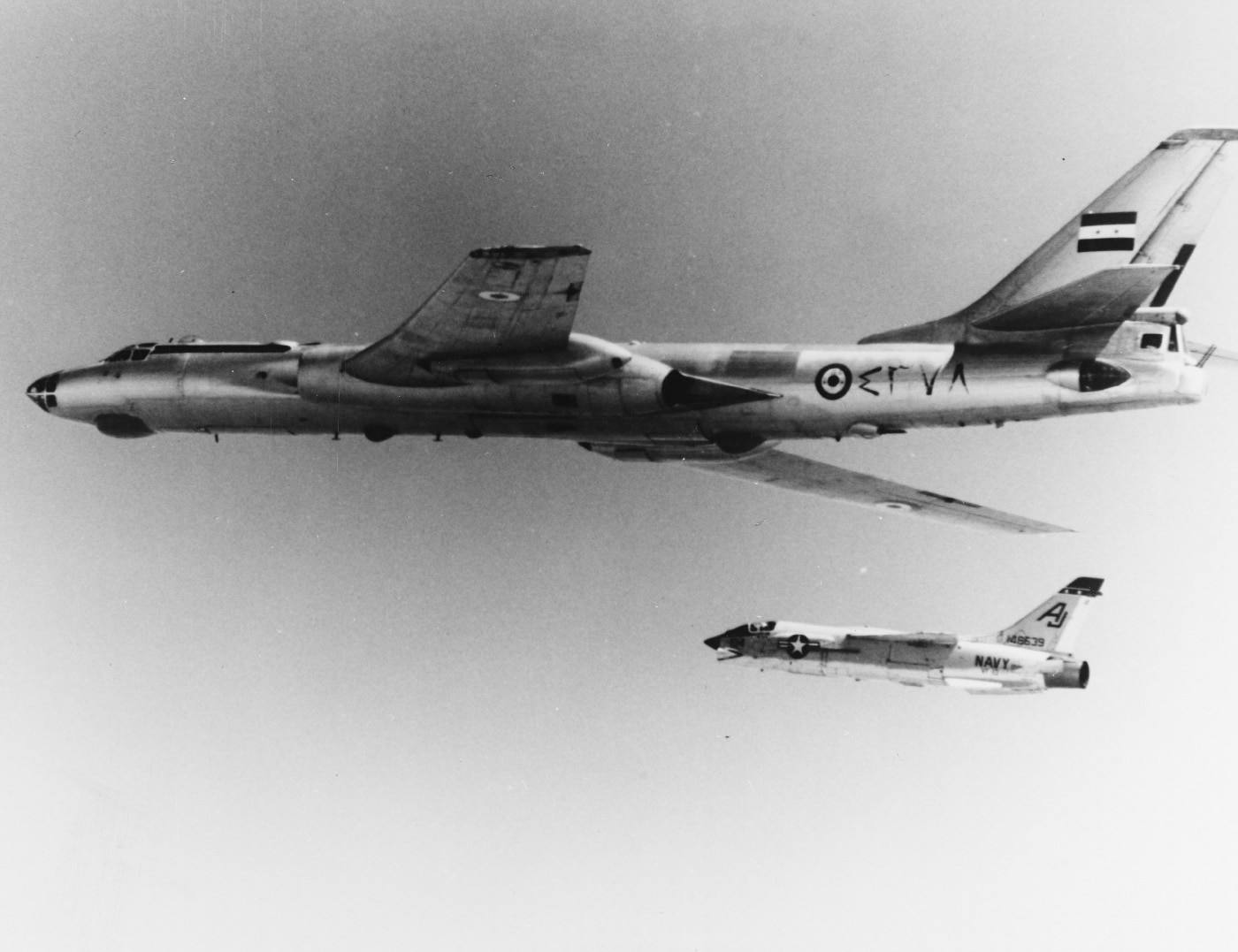 In this photo, a U.S.N. F-8 escorts an Egyptian TU-16 Badger bomber away from a NATO exercise in the Mediterranean Sea. The USN was working with the British Marines and French Navy in a combined arms exercise. 