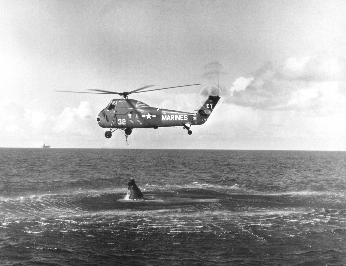 Shown is a US Marine helicopter attempting to life a NASA Mercury capsule from the Atlantic Ocean. An accident on the capsule ejected the hatch and caused seawater to pour into the compartment. Astronaut Gun Grissom was able to escape and was rescued before the capsule sunk to the bottom of the sea. 