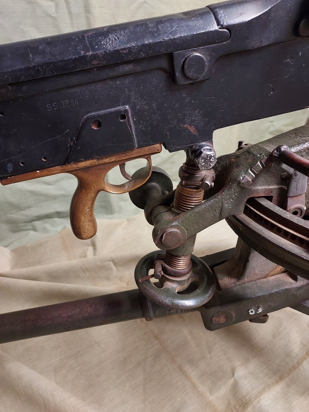This is a detail photo of the pistol grip and trigger of the machine gun. The line of nearly identical Hotchkiss designs bucked some of the conventional wisdom starting with the Model 1897. This final form by Hotchkiss Armament was both different and easy to operate.