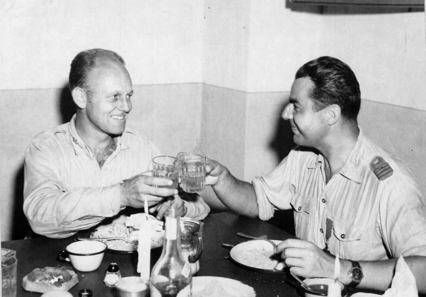 This is an image of Lt. Col. Gunn and Captain Cantacuzino celebrating their successful escape with a meal and a drink in Italy.