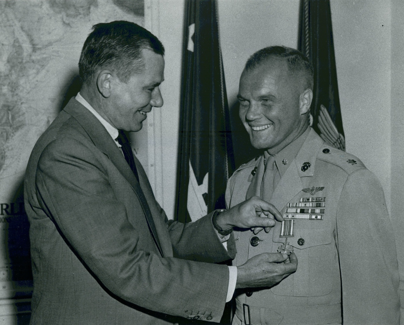 In this photo, Major John H. Glenn, Jr., U.S.M.C., received the Distinguished Flying Cross from the Secretary of the Navy. Glenn used the F-8 to become the first person to cross the continent faster than the speed of sound. John Glenn would later go on to be an integral part of the U.S. space program.
