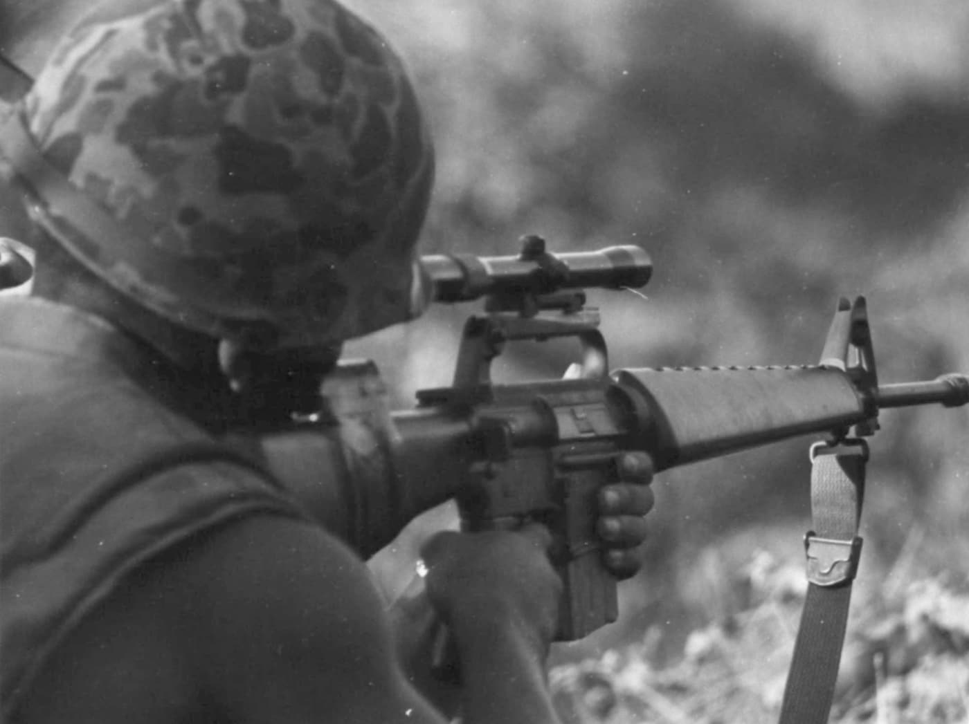 This is a rare image of a Korean Marine sniper in Vietnam. His M16A1 is fitted with a rifle scope and a square forward assist. The image shows him aiming from over his right shoulder. The photo was taken in 1967 during Operation Dragon Fire on Batangan Peninsula.