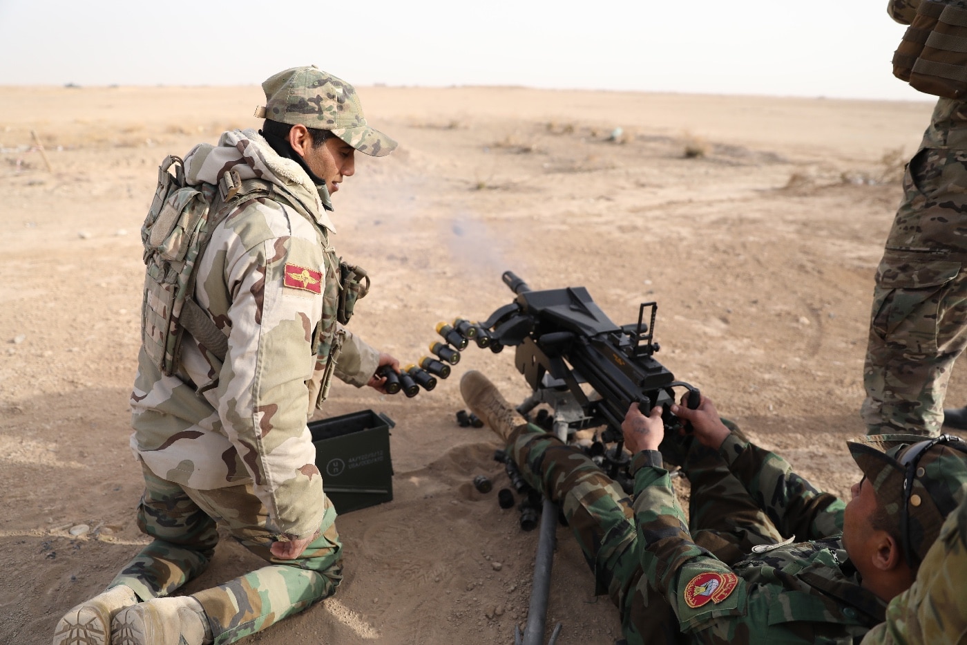 The image shows members of the Qwat Khasa, Iraqi army, work together to engage targets with a Mark 19 40 mm grenade machine gun at the Besmaya Range Complex, Iraq, Jan. 24, 2018. Training at building partner capacity sites is an integral part of Combined Joint Task Force – Operation Inherent Resolve’s global Coalition effort to train Iraqi security forces personnel to secure and stabilize their country and deter the resurgence of ISIS.