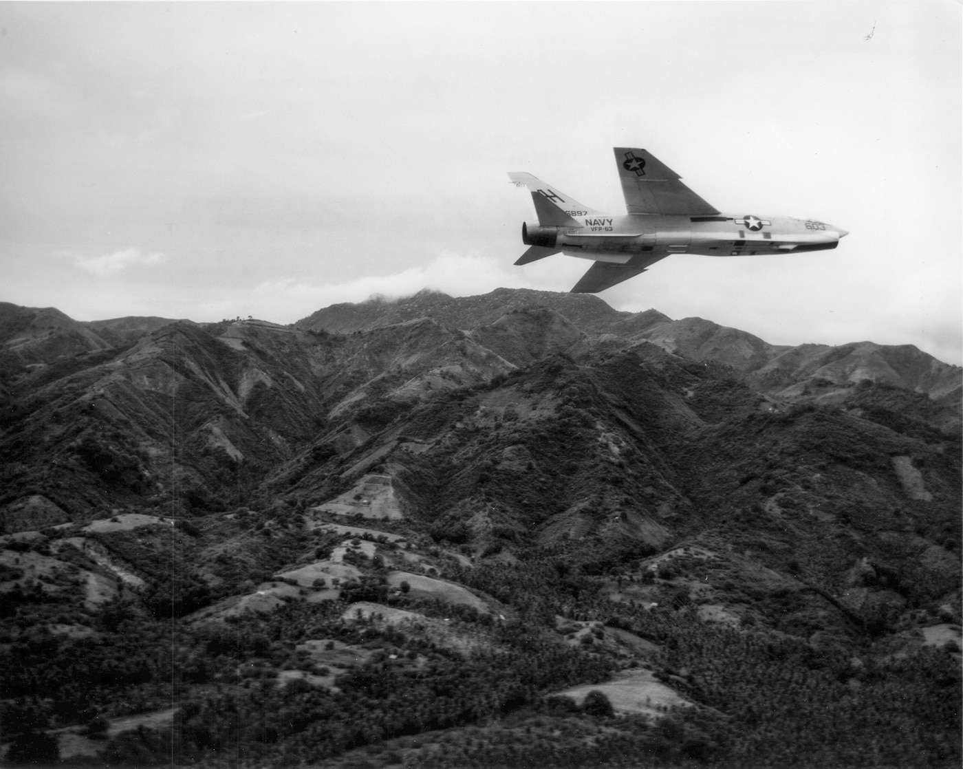 In this photo, a RF-8 Crusader, which was a photo reconnaissance version of the F-8, rolls in to make a photo-reconnaissance run during the Vietnam War. The reconnaissance version of the aircraft was used during the Cuban Missile Crisis and other events. The national naval aviation museum at Patriots Point displayed one of these aircraft since the last operational one was retired. 