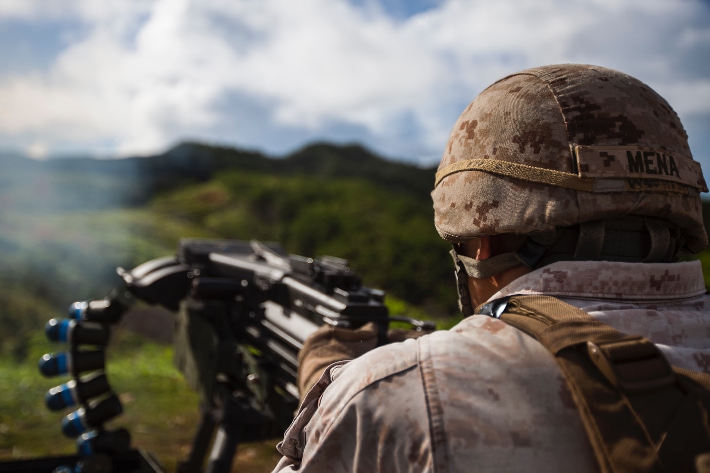 The image shows Sergeant Oscar Mena fires a Mk-19 40mm grenade launcher during a crew-served weapons familiarization shoot for Battalion Landing Team 3rd Battalion, 5th Marines, 31st Marine Expeditionary Unit, Aug. 20, 2014. 