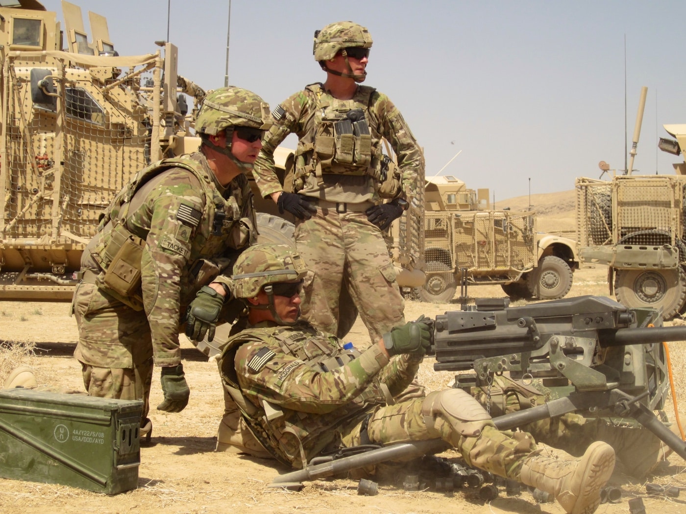 This photo shows US troops in training in Afghanistan. Outside his joint combat outpost in Baghlan province, Staff Sgt. Adam Tackett, the platoon sergeant for 1st platoon, Blackfoot Troop, 6th Squadron, 4th Cavalry Regiment, 3rd Brigade Combat Team, 1st Infantry Division trains Spc. McDonald on the MK19 grenade launcher. Sgt. Nicholas King, a section sergeant in 1st platoon watches the rounds impact downrange. The 6th Squadron, 4th Cavalry Regiment, 3rd Brigade Combat Team, 1st Infantry Division, from Fort Knox, Ky., in support of Operation Enduring Freedom.
