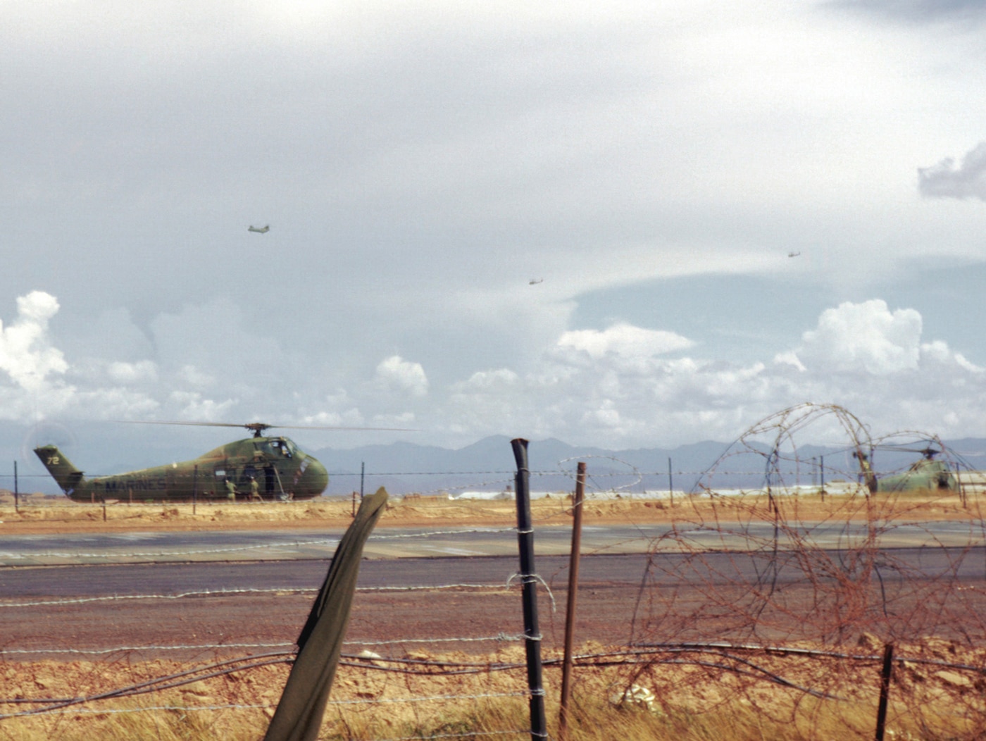 In this image, several US Marine CH-34 helicopters sit on the runway at Dong Ha in 1967. Marines are boarding them with machine guns and other gear for combat missions against the North Vietnam Army and Viet Cong. Gunship versions of these helicopters were frequently armed with machine guns and two rocket pods.