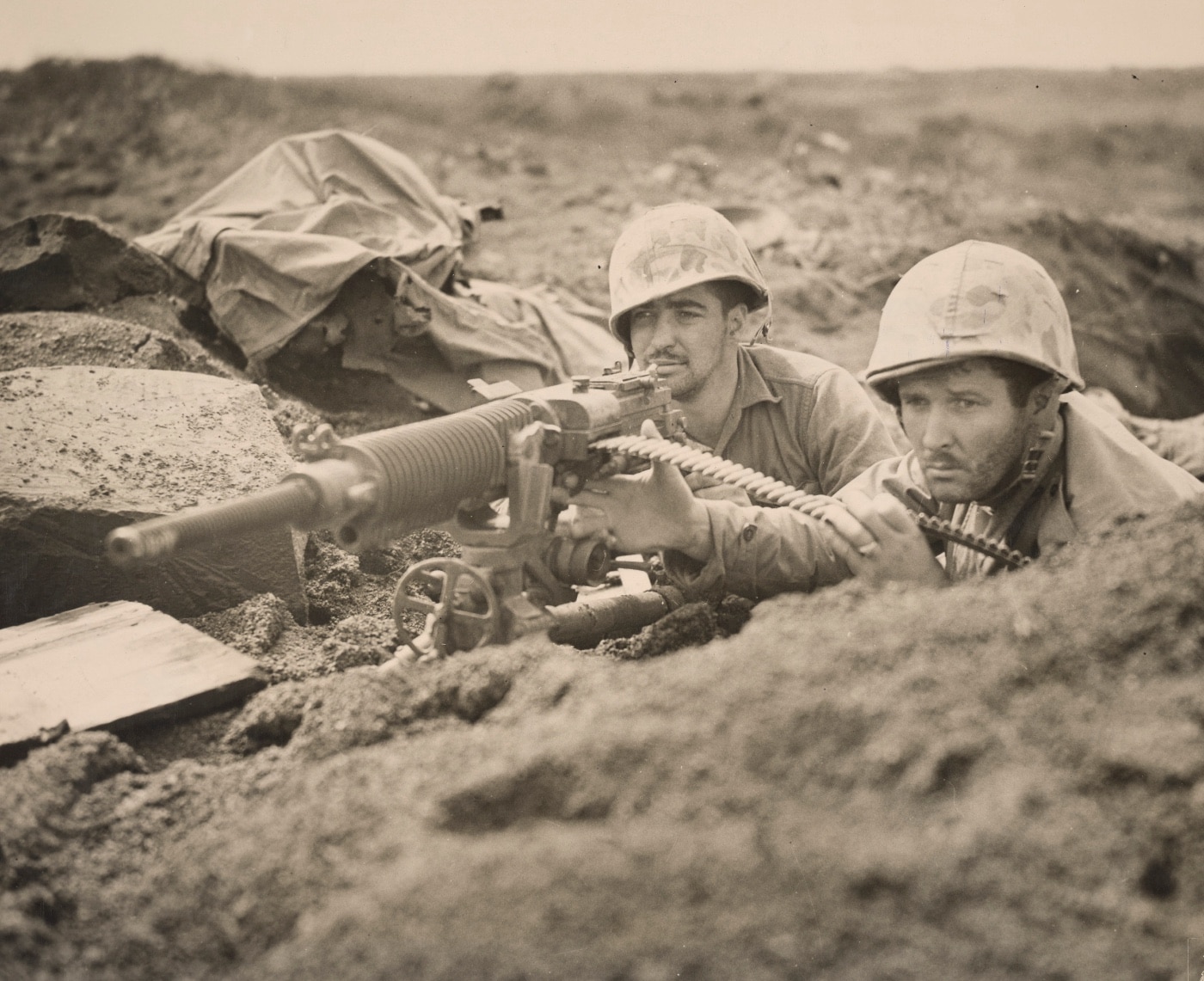 Shown are two U.S. Marines manning a Japanese Type 3 heavy machine gun during the Battle of Iwo Jima in World War II. The Type 3 was based on the French Hotchkiss Model 1914 machine gun chambered for the 6.5x50 Arisaka cartridge. Japan licensed the design and made a number of variations of the crew served firearm. 