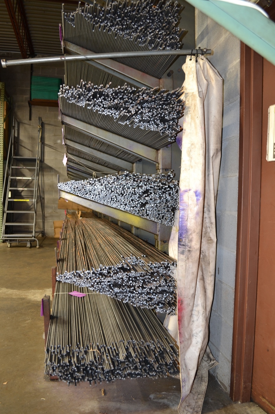 Sitting on these racks are bars of US-made steel that will be fed into CNC machines to make Chapman Tools.