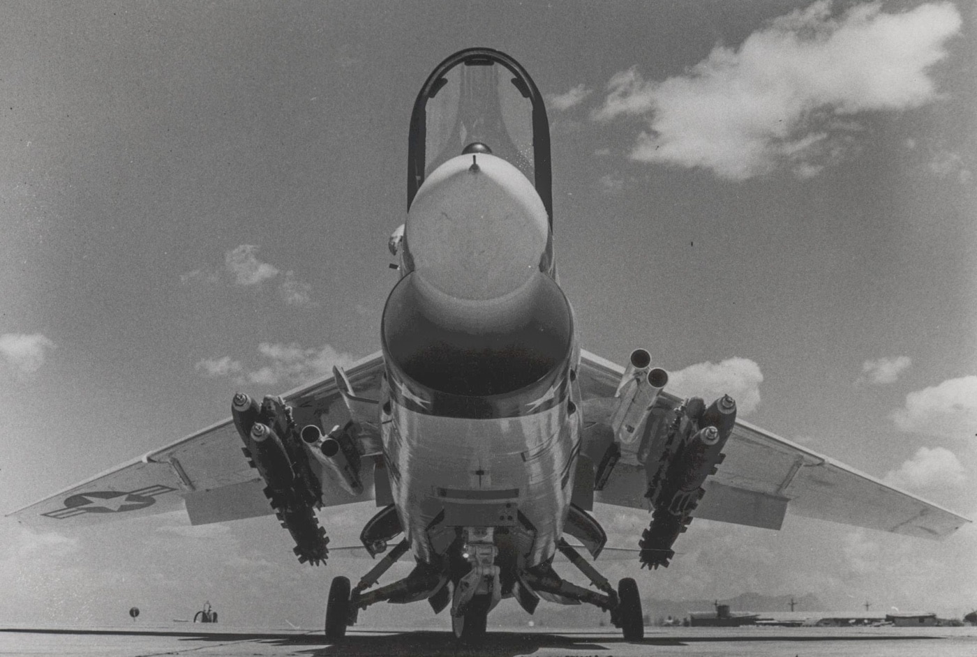 In this photo, the underside of the F-8 Crusader is exposed showing the air-to-ground ordnance loaded for a combat mission in the Vietnam War. The Navy Crusader was also used by the Marine Corps which is the service branch operating the plane shown. Eventually the planes were replaced by the F-4 Phantom II. 