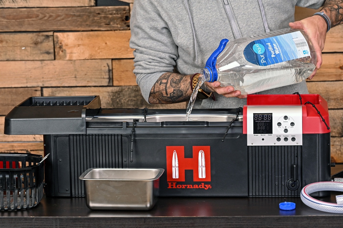 The author adds purified water to the storage tank in this photo. Adding tap water can work, but keep in mind that tap water often contains minerals and other impurities that can reduce the effectiveness of the cleaner. When employing sonic cleaning to clean an AR or other firearm, you want to set up the solution correctly.