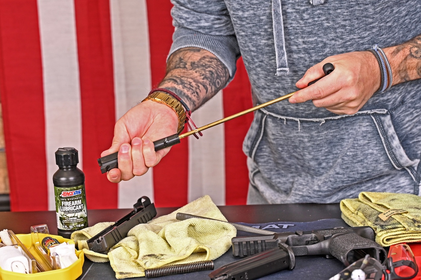 The author is working to get his pistol clean in this photo. He is showing how to clean the barrel with patches. The general idea is to keep running patches through the barrel — from the breech end if possible — until you start getting clean patches. When you run it through the barrel, you do not want to damage the muzzle with your cleaning rod. That's why many people recommend pushing the patches through from the back of the barrel.