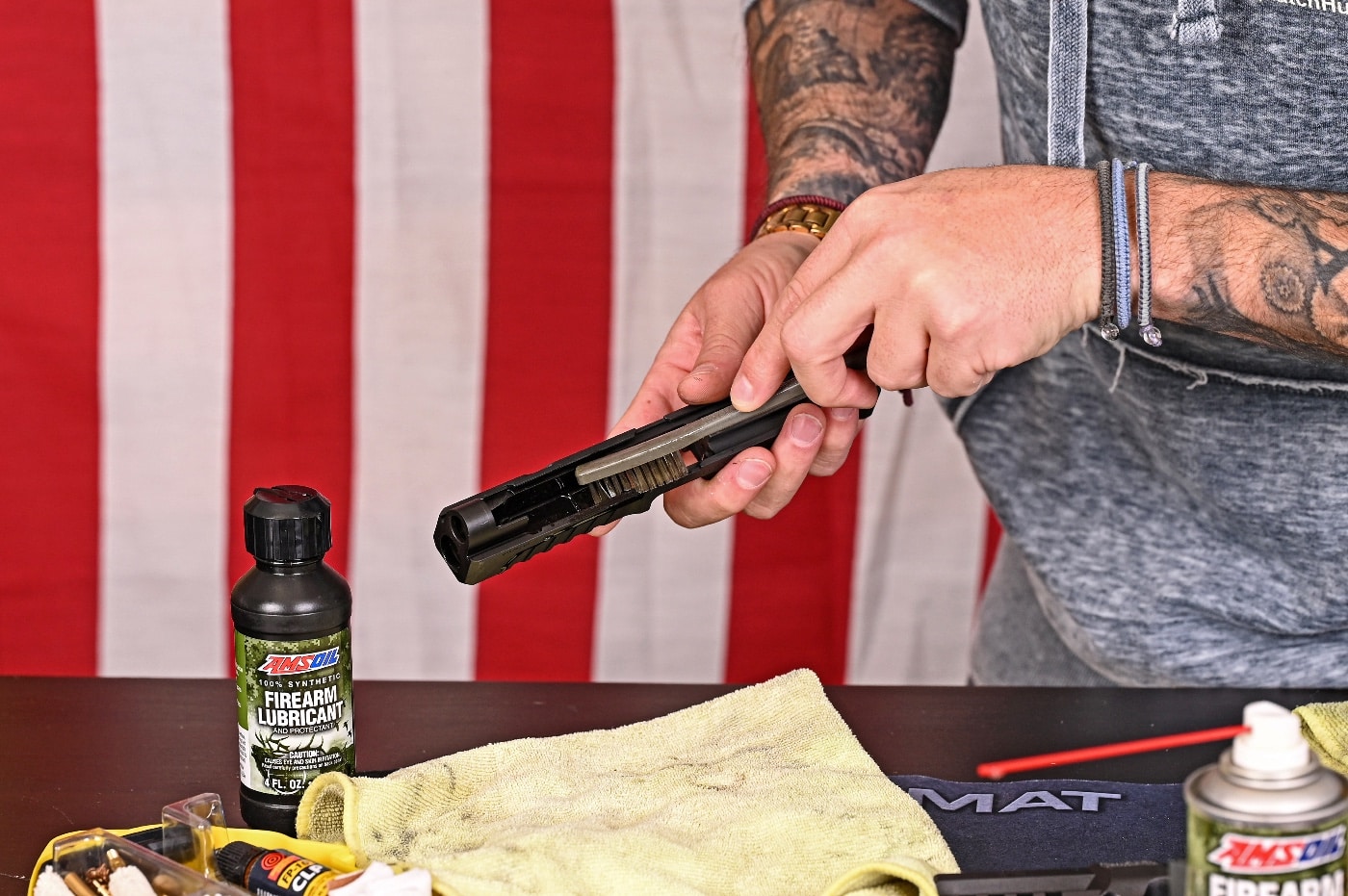 Here the author demonstrates how to clean the gun's slide in this photo. Even if your gun stays in a gun safe most of the time, dust and dirt can still find its way into the slide rails. You should want to clean the gun on some regular basis to ensure it's clean if you ever need it.