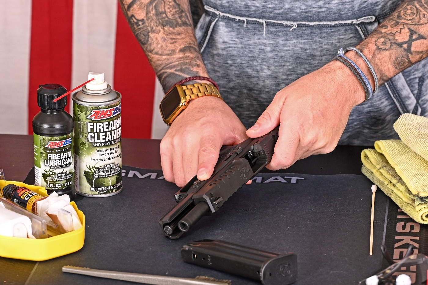 The author demonstrates proper gun handling in this photo. He is preparing to disassemble the gun, and points the gun in a safe direction. He removes the magazine and checks the chamber prior to giving it a general cleaning. Many gun accidents happen when people aren't sure the gun is unloaded. You must ensure the gun is unloaded prior to cleaning it. Keep the gun pointed in a safe direction until it is completely checked and field stripped.