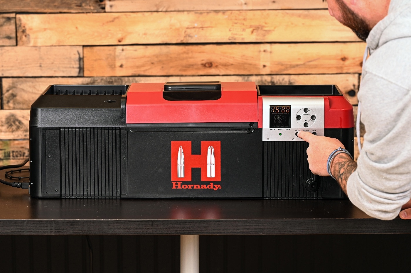 In this photo, the author demonstrates how to set the timer for the cleaning cycle. Sort of a washing machine for your firearms, the Hornady ultrasonic cleaner proved to be very effective at removing dirt and burned gunpowder from guns.