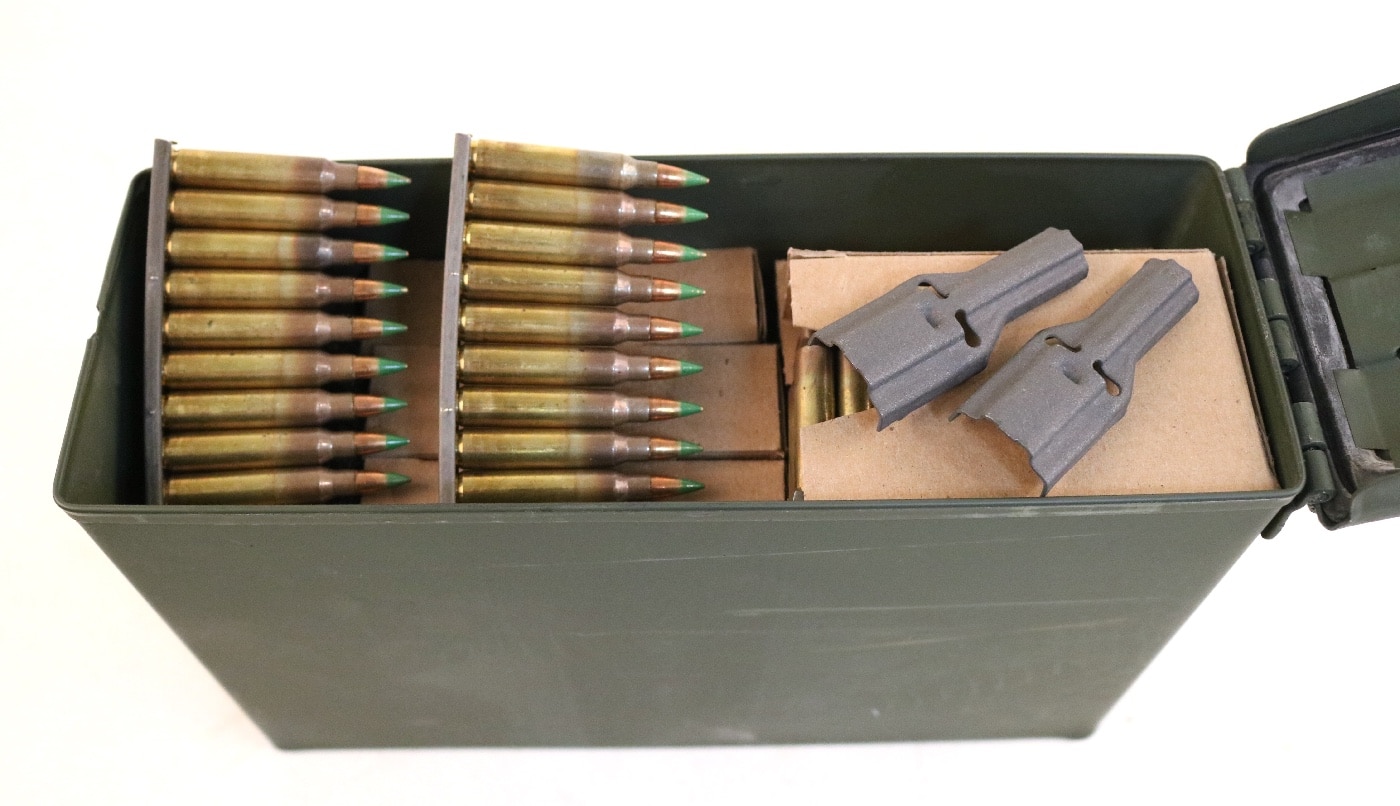The author shows storing green tip 5.56 NATO ammunition on stripper clips. He also recommends making sure you have stripper clip guides for easy magazine loading. The amount of ammo your store should be relative to the kinds of shooting you do. Without ammunition, guns are virtually useless tools. The last thing you want is an expensive club that cannot put food on the table or defend your family against attack. Keep your ammo stored in a safe, dry cool place.