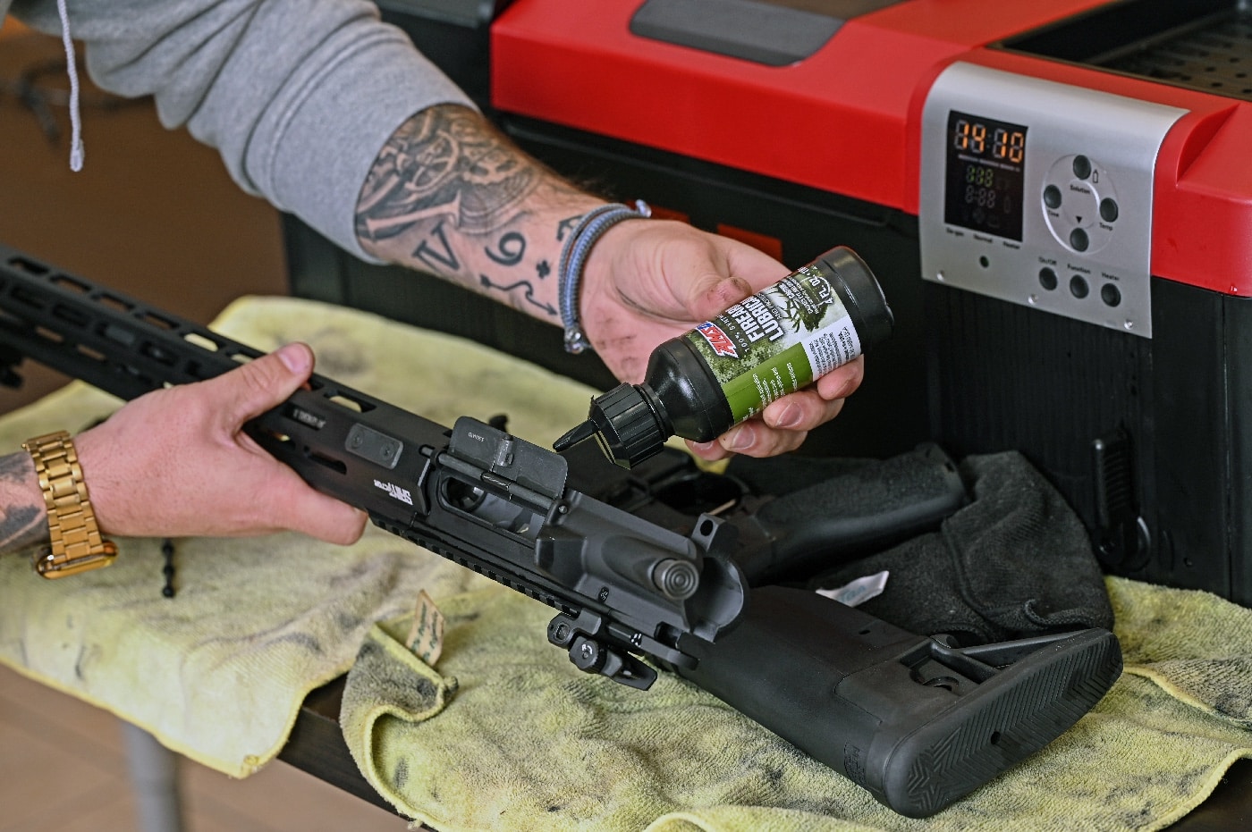 In this photo, the author adds a thin film of lube to his firearm after pulling it from the Hornady Lock-n-Load Hot Tub Sonic Cleaner. When you pull it out of the tub, be sure to wipe it down and blow it off if you have an air compressor to ensure all of the cleaning fluid is removed. Then add a bit of oil to reduce wear.