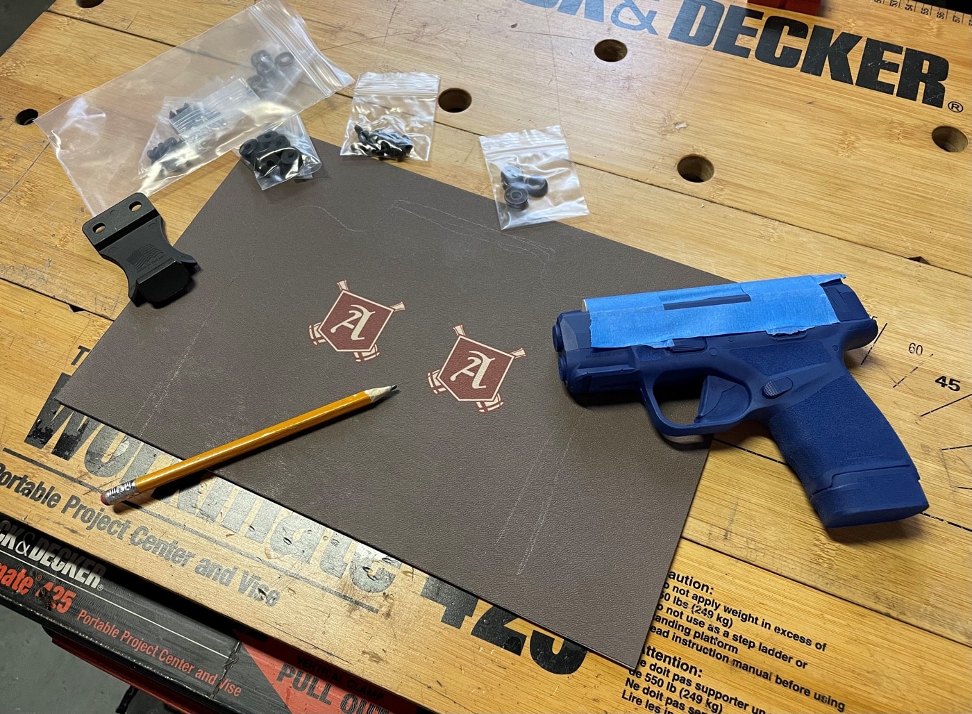 In this photo, the author shows us all of the parts he used to make a Kydex CCW rig for his Springfield Armory Hellcat 9mm pistol. He shows the various screws and attachment hardware, belt clips and Kydex sheeting. If you want to learn how to make your own holster, be sure to take your time to get it right. The finished product will definitely be worth it. The first step is to make sure you have all of your parts.