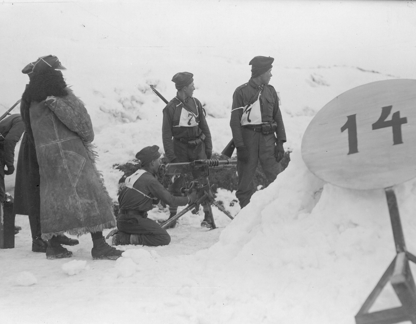 This unique photo is from an international skiiing competition. It shows army troops from various countries shooting the Hotchkiss as part of a relay race. 
