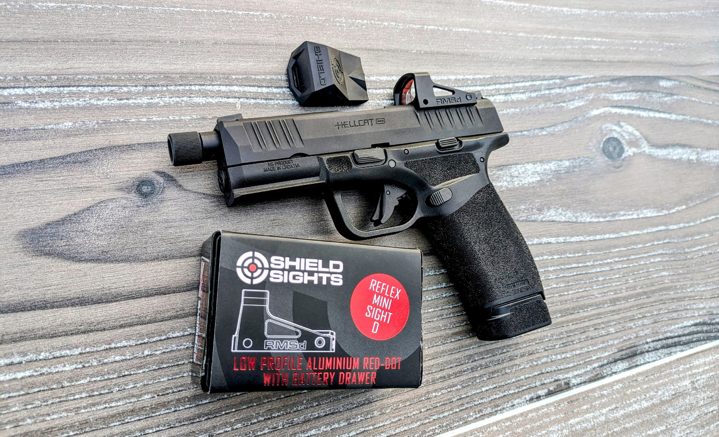 Shown in this photo is the author's self-defense pistol with the Shield RMSd and its packaging. The exterior housing of the RMSd is made from aerospace-grade aluminum, and it's finished in a matte black color. This not only gives it a sleek, professional look but also ensures durability and resistance to the wear and tear of daily carry. In terms of size and weight, the RMSd is incredibly compact and lightweight. Measuring just 42 x 25 x 23 mm (1.7 x 1.0 x 0.9 inches) and weighing only 17.5 grams (0.61 ounces), it adds negligible bulk to a personal protection pistol.