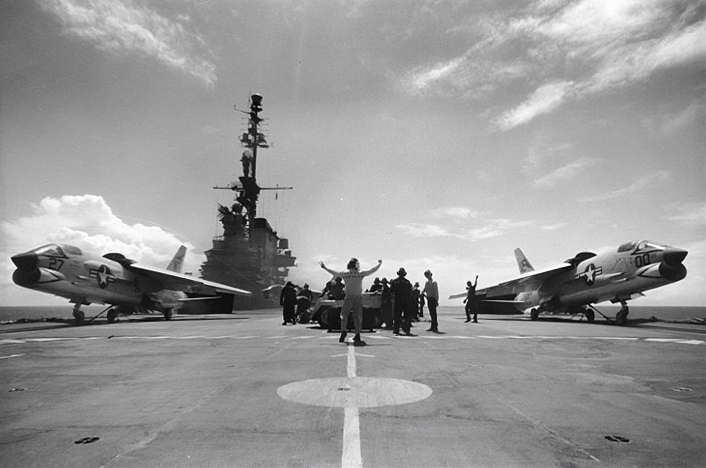 Shown are two F-8 Crusaders that are on the forward catapults of the USS Midway. The Midway was used for pilot training by the United States Navy. Naval Air Station training was the first step where visibility for the pilot was at a maximum. Service with the United States began on 21 August 1956 and was retired in 1999. 