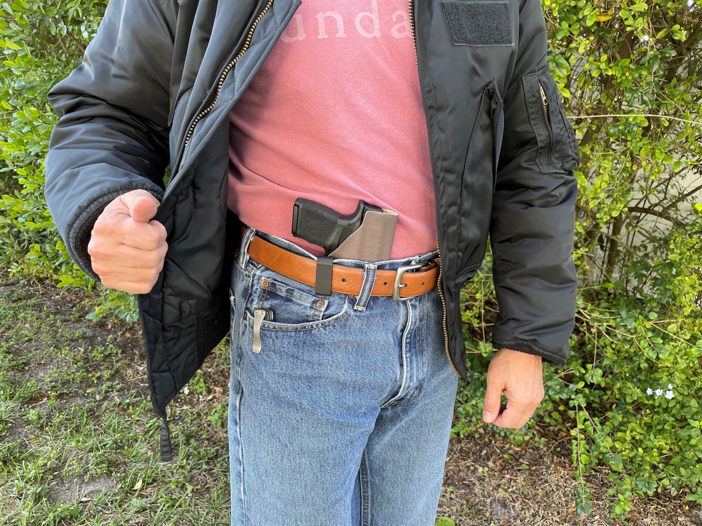 In this photo, the author shows the holster in use with his Springfield Armory Hellcat micro compact 9mm pistol. He was able to make the holster with relative ease. Many of the tools he used could be replaced by a single Dremel kit, though full size shop tools are likely easier to work with. a homemade Kydex holster