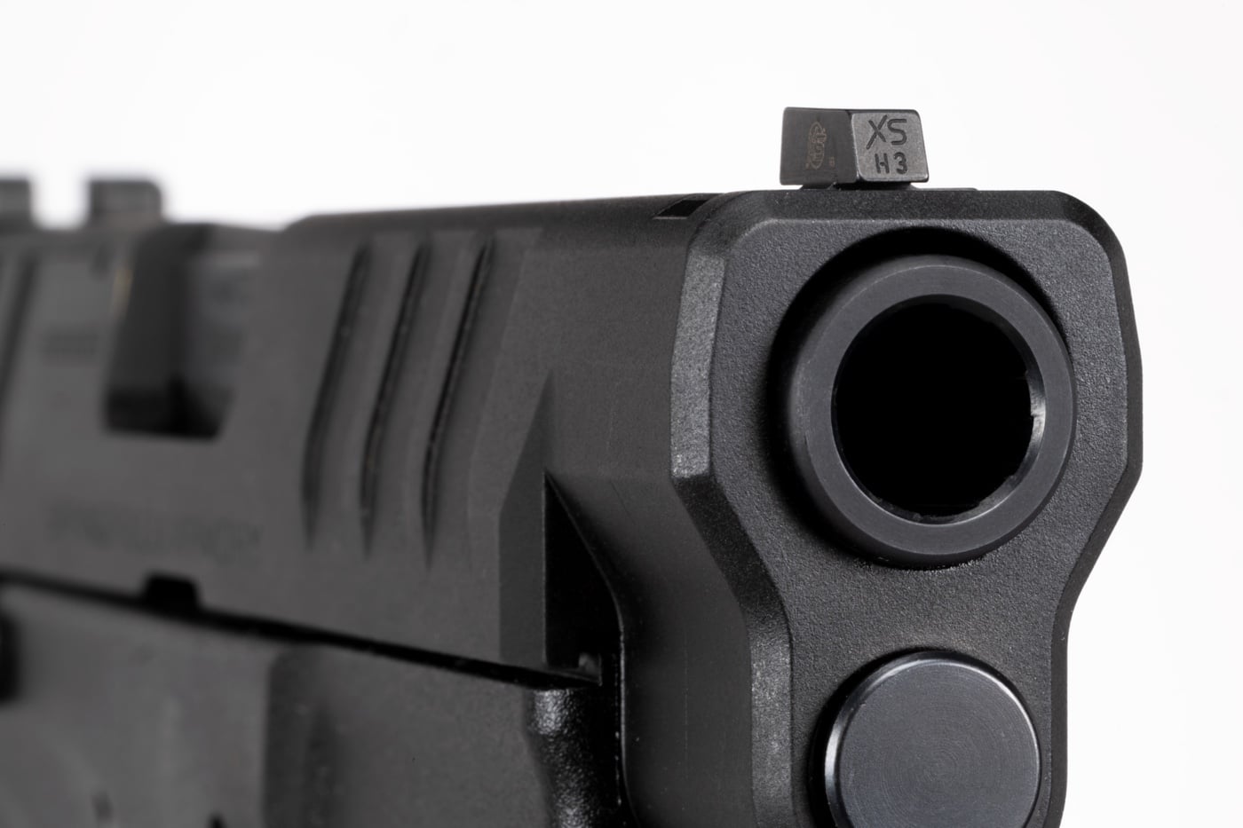 In this review, the author installs a set of R3D 2.0 sights from XS Sights on his Springfield XD-M 10mm pistol. Shown is the front sight that combines a tritium vial with a photoluminescent ring. The R3D sights are great in day or night conditions for concealed carry on any firearm.