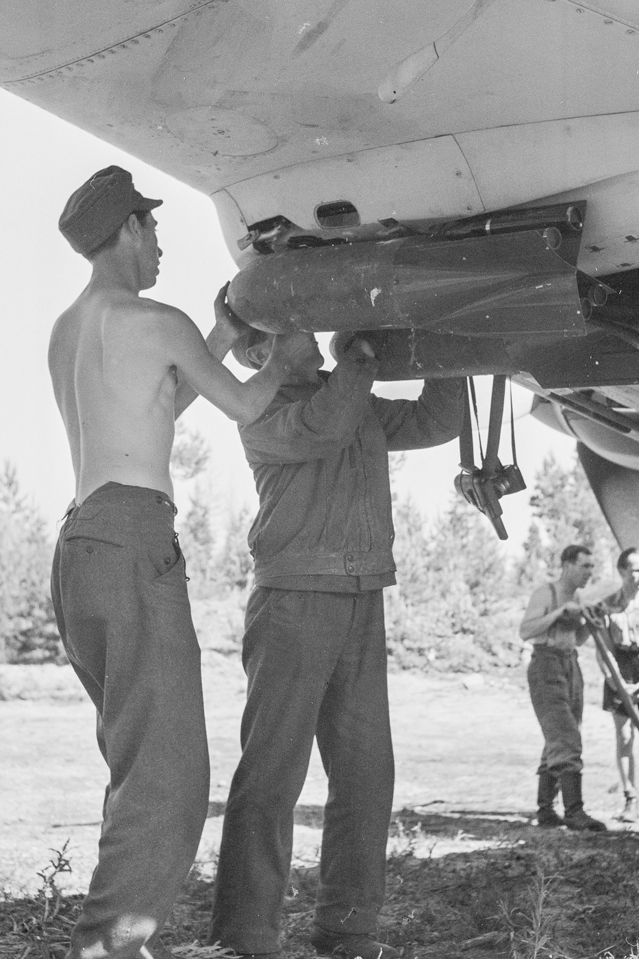 Shown here are two German members of the ground crew attaching a 50 kg bomb to the underside of a Stuka wing. A total of four (4) of these bombs could be attached to the plane's wings.