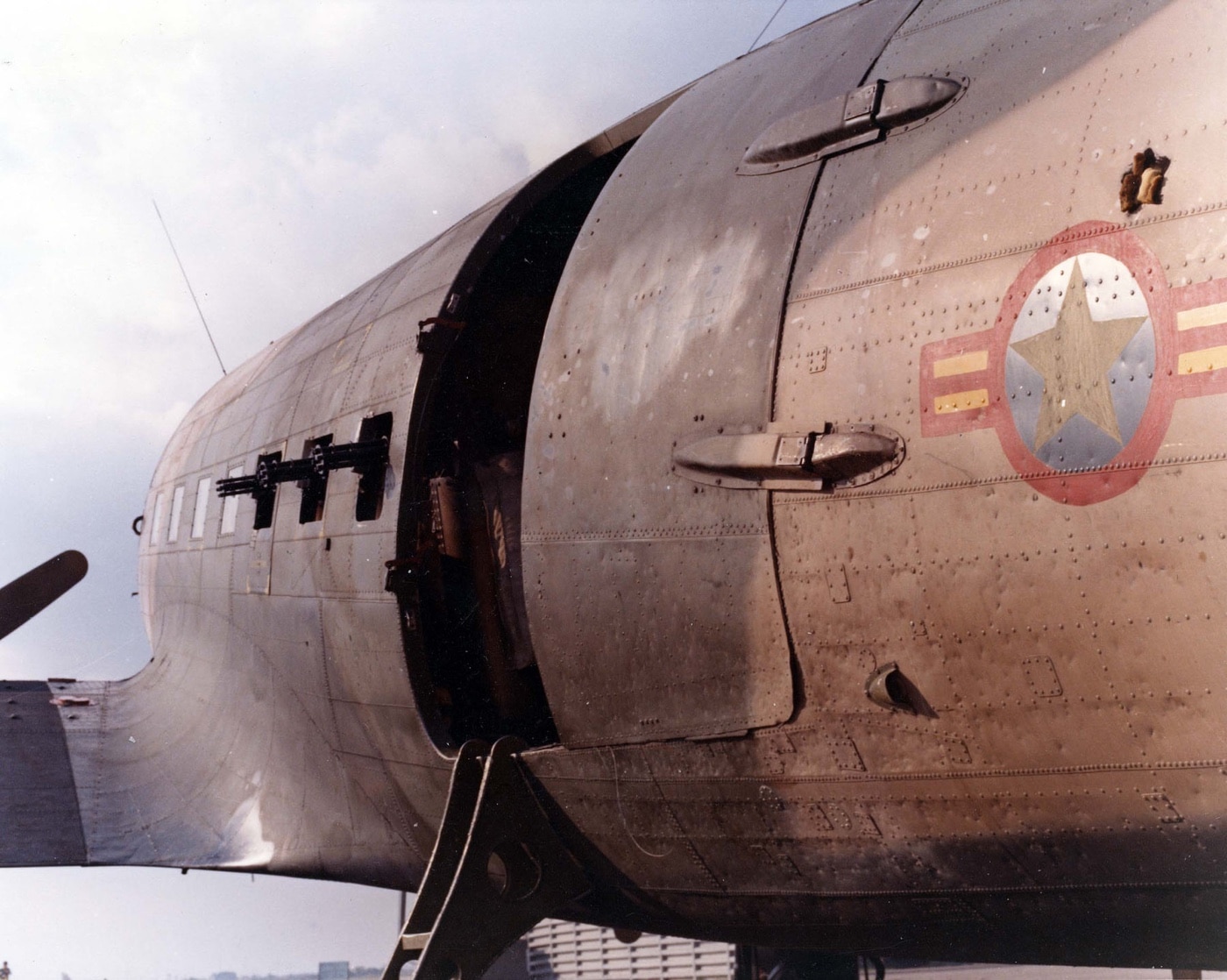 In this image we see an AC-47 that is being given to the South Vietnam Air Force. These planes were provided to South Vietnam and Laos as part of President Nixon's Vietnamization policy on the Vietnam War to beat North Vietnam. AC-47 planes were also provided to the Colombian Air Force, Royal Lao Air Force and Royal Thai Air Force. Vietnamization was a policy of the Richard Nixon administration to end U.S. involvement in the Vietnam War through a program to "expand, equip, and train South Vietnamese forces and assign to them an ever-increasing combat role, at the same time steadily reducing the number of U.S. combat troops".