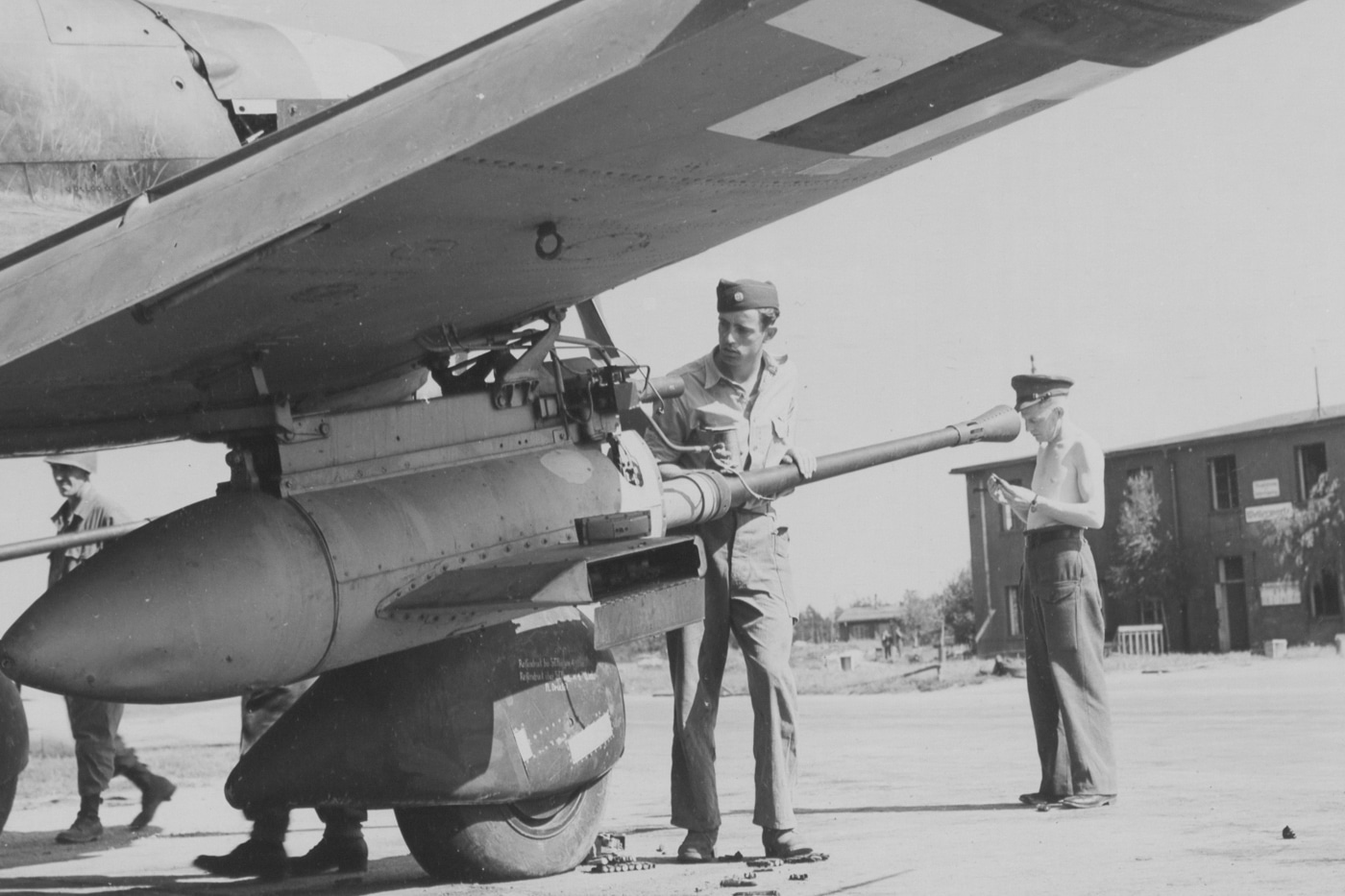 In this photo, we see Americans with the United States Army Air Force examining the armament on a captured Stuka. The 37mm cannon turned the Stuka units into tank busters. 