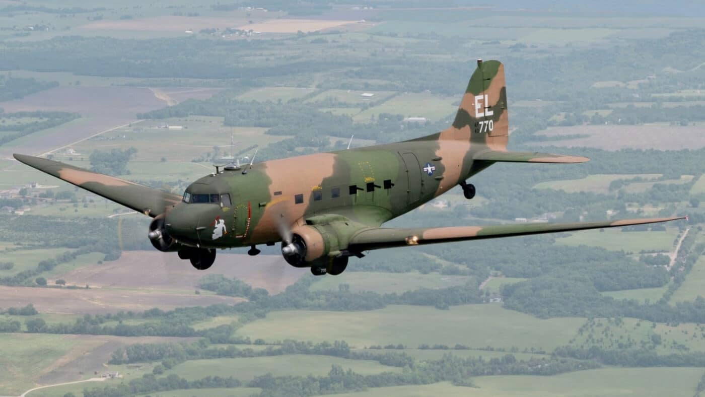 In this photograph, we see a restored Douglas AC-47 Spooky in flight over Kansas in the United States of America. It sports a woodland type camouflage paint scheme that was used in the Vietnam War. AC-47 gunships were often called on to support troops in the field where artillery could not reach. Also, they were excellent for air base and fire base defense. Firebases in the U.S.-involvement Vietnam War, were a type of military base,. It may refer to: Firebase 6, Central Highlands Firebase Airborne, central South Vietnam Firebase Argonne, Quảng Trị Province Firebase Atkinson, southwest South Vietnam Firebase Bastogne, Thua Thien Province Firebase Berchtesgaden Thừa Thiên–Huế Firebase Betty, Bình Thuận Province Firebase Bird or other southern South Vietnam Firebase.