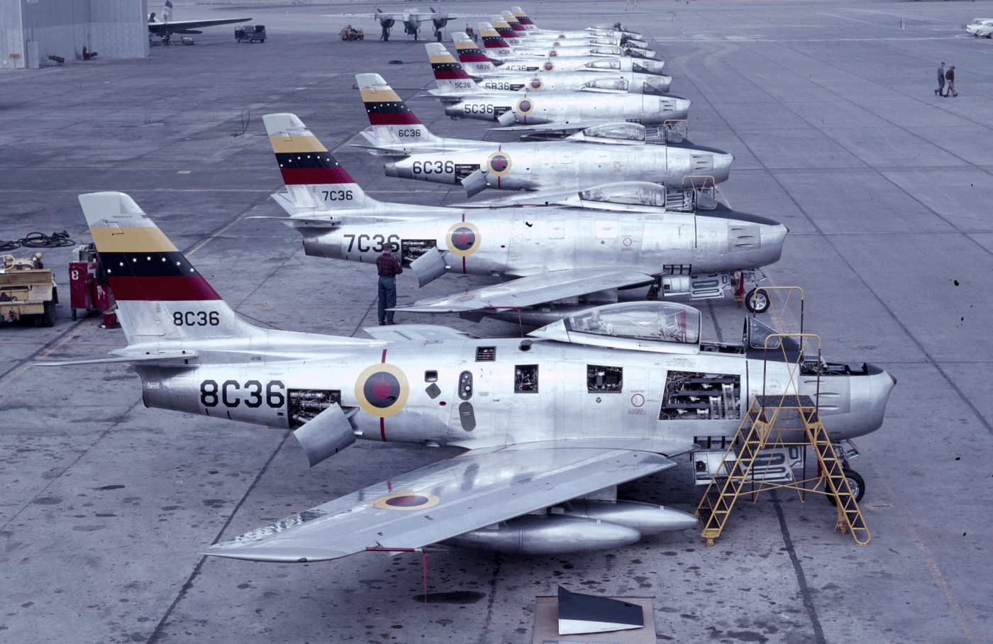 In this image, we see a line of North American F-86F fighters that were being sold to Venezuela. While the Sabre is best known in the service of the United States, it flew in the air forces of many US allies. 